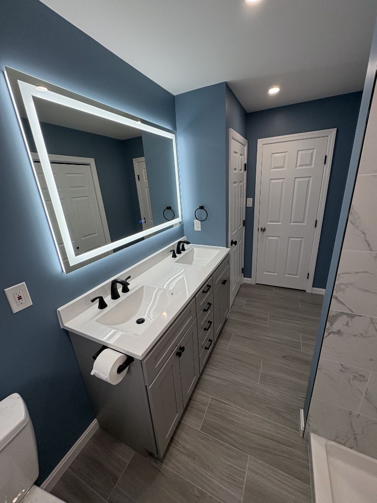 Wide-angle bathroom remodel with double vanity and LED mirror