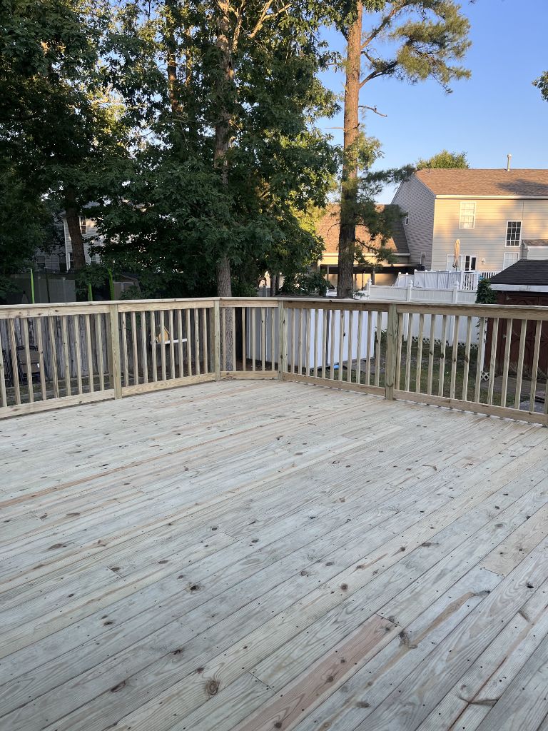 Large pressure treated wood deck — open area with natural railing