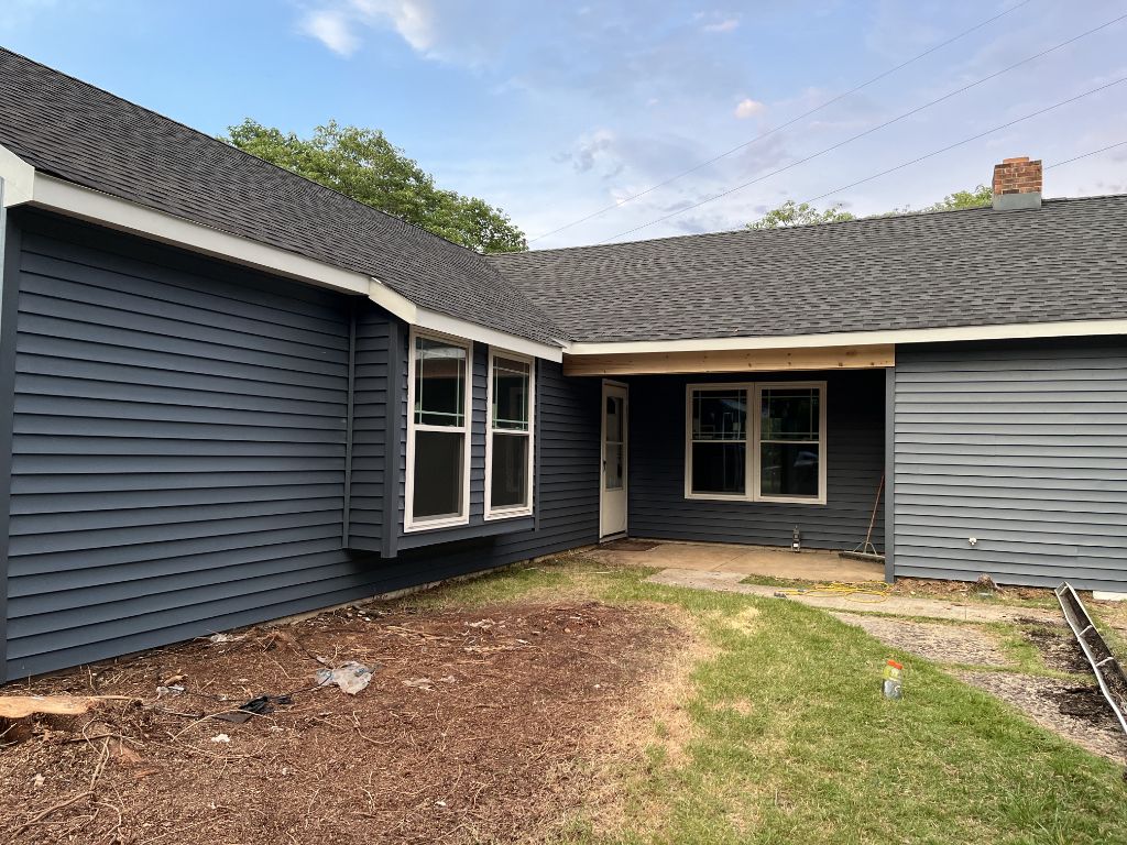 Dark charcoal siding on rear elevation with door and windows