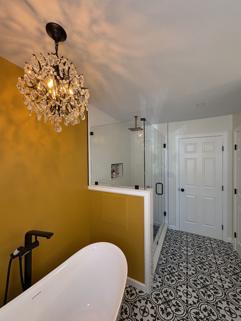 Luxury bathroom remodel with freestanding tub and herringbone tile